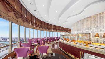 Enjoy a panoramic city view from our restaurant, where you can dine on a variety of food and drink options.