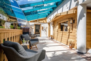 A sunlit interior with a wooden ceiling, a seating area with chairs, and a view of the outside. - Best Western Plus Hotel Erb (Vaterstetten)