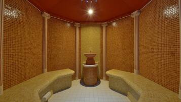 Seating area with a central column and two benches.
