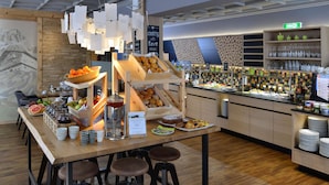 A buffet setup with various food items and a sign indicating cooking with love. - Best Western Plus Hotel Erb (Vaterstetten)