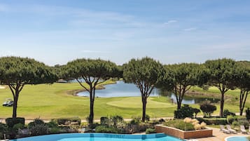 Relax by the serene pool surrounded by lush landscaping and a nearby golf course.