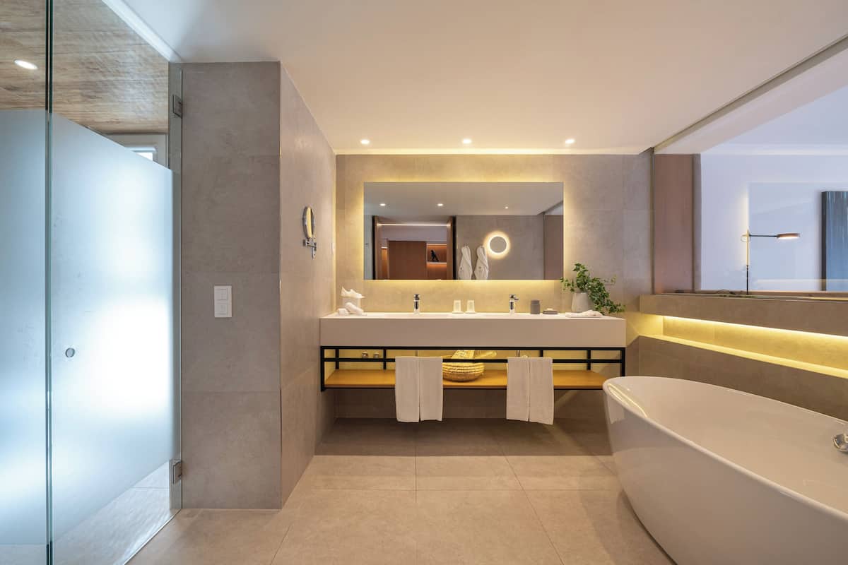 signature suite, balcony | bathroom | shower, rainfall showerhead, hair dryer, bathrobes