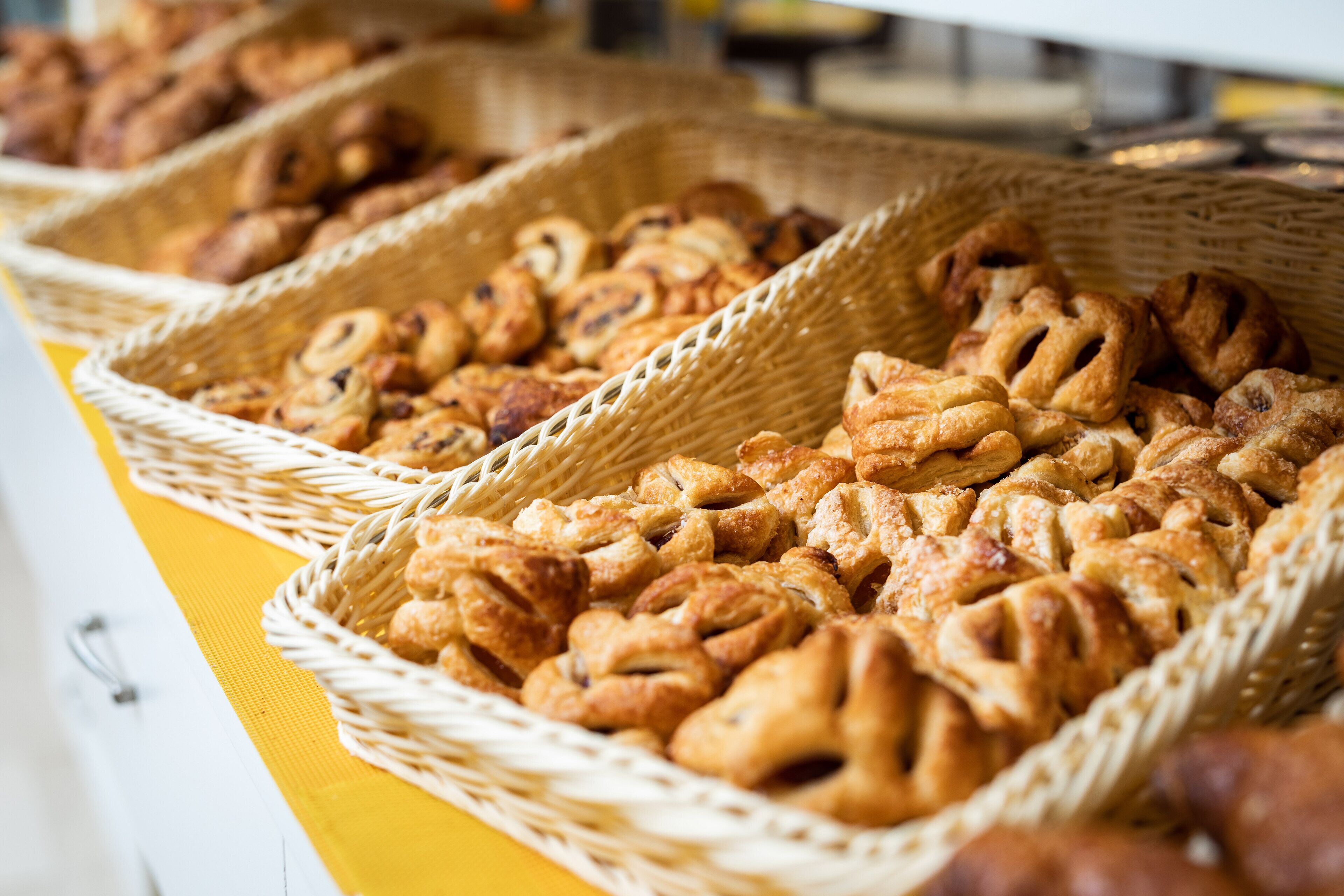 Wicker baskets filled with pastries on a table.