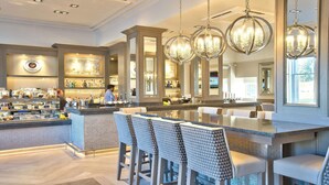 A bar area with a counter, bar stools, and hanging chandeliers. - Inverness Palace Hotel & Spa, WorldHotels Distinctive (Inverness)