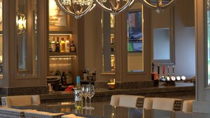 A bar area with a long counter, multiple bar stools, and three chandeliers. - Inverness Palace Hotel & Spa, WorldHotels Distinctive (Inverness)