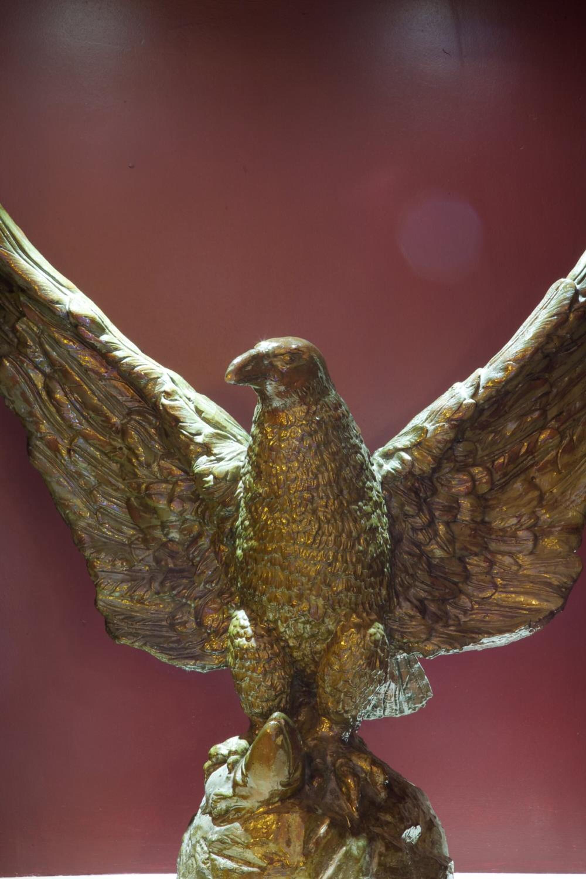 A bronze eagle sculpture with outstretched wings.