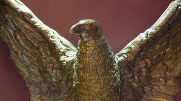 A bronze eagle sculpture with outstretched wings.