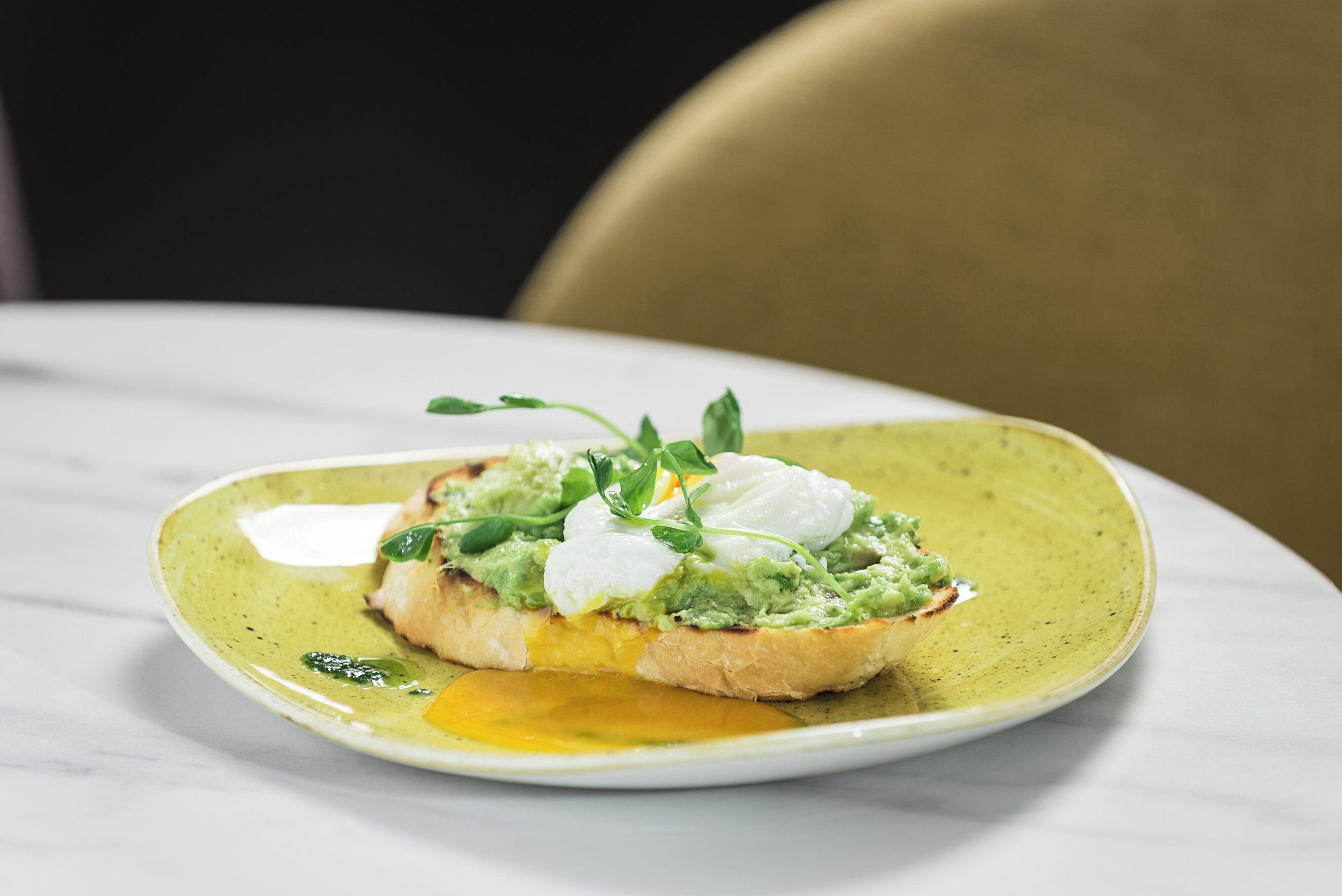 A plate with a food item on a white table.