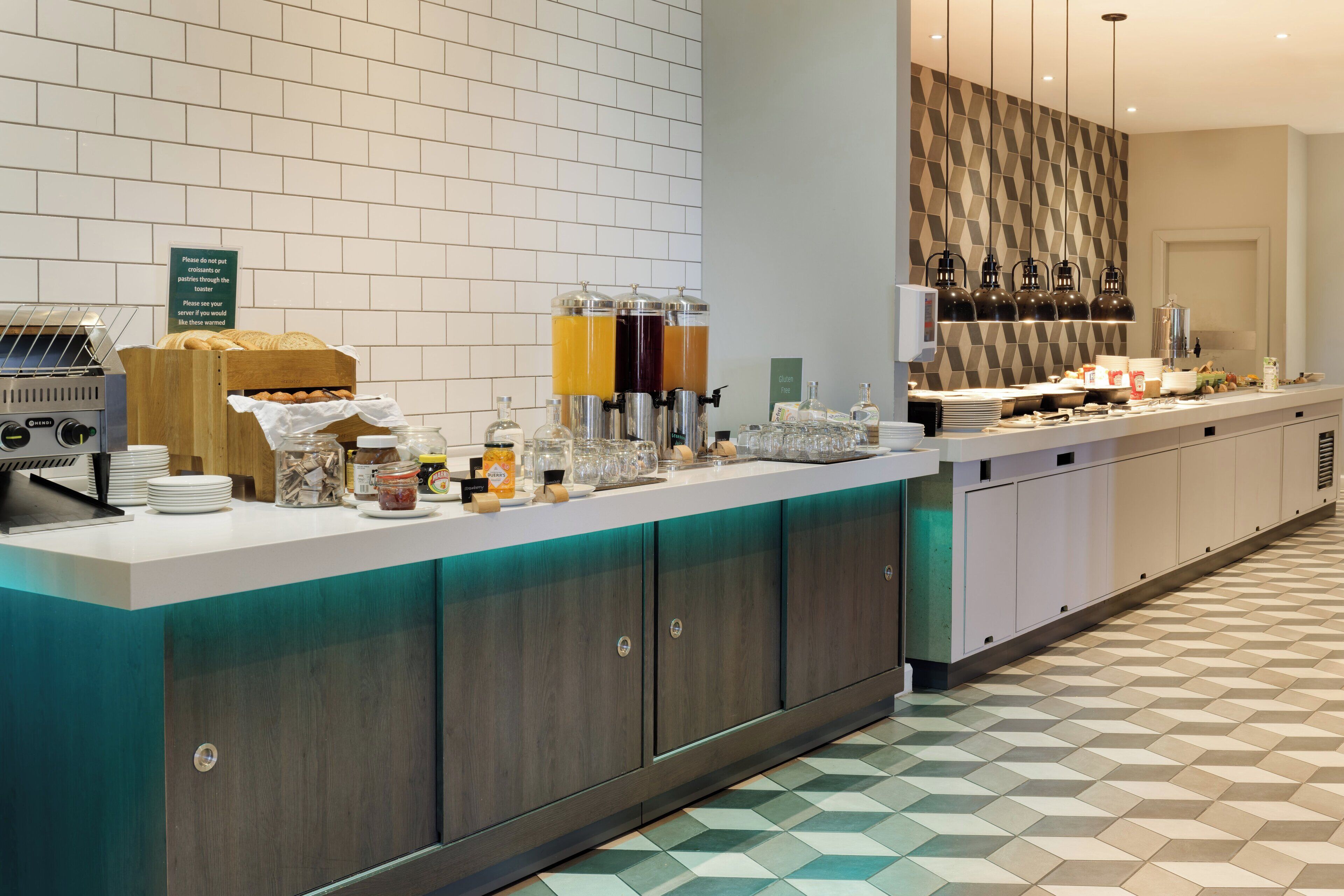 A buffet setup with a variety of food items, a coffee station, and beverage dispensers.