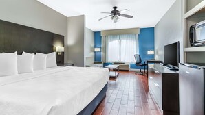 A modern hotel room with a large bed, a desk, a television, and a ceiling fan. - Best Western Port Lavaca Inn (Port Lavaca)