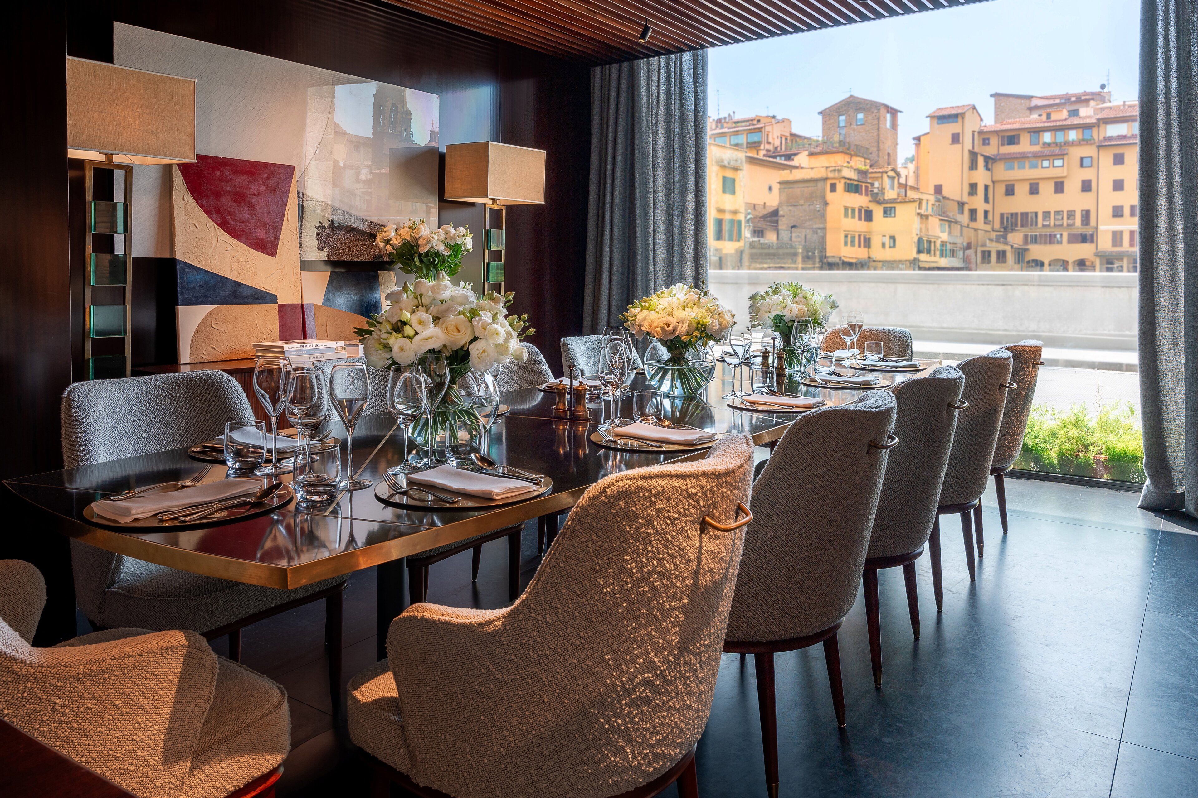 A dining area with a view of buildings through a window.