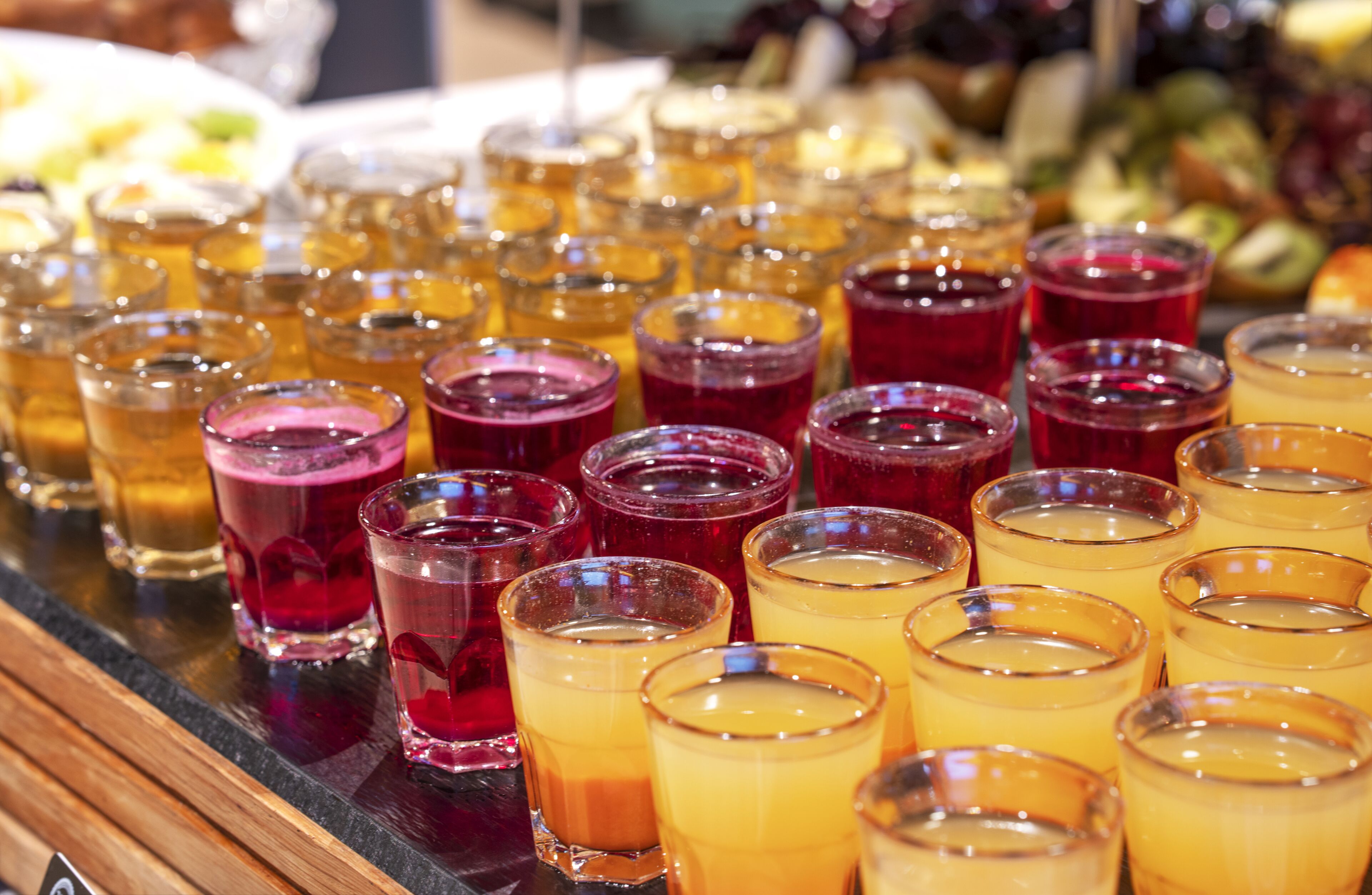 A bar area with multiple glasses of various beverages.