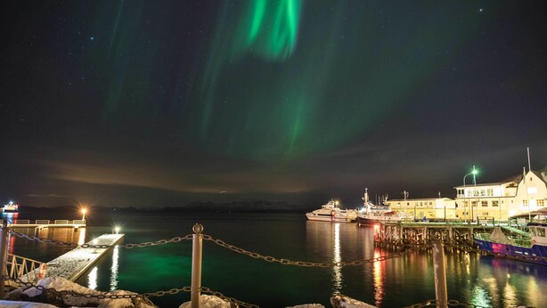 A waterfront hotel with a dock, a pier, and a building with a lighted sign. - Thon Hotel Harstad (Harstad)