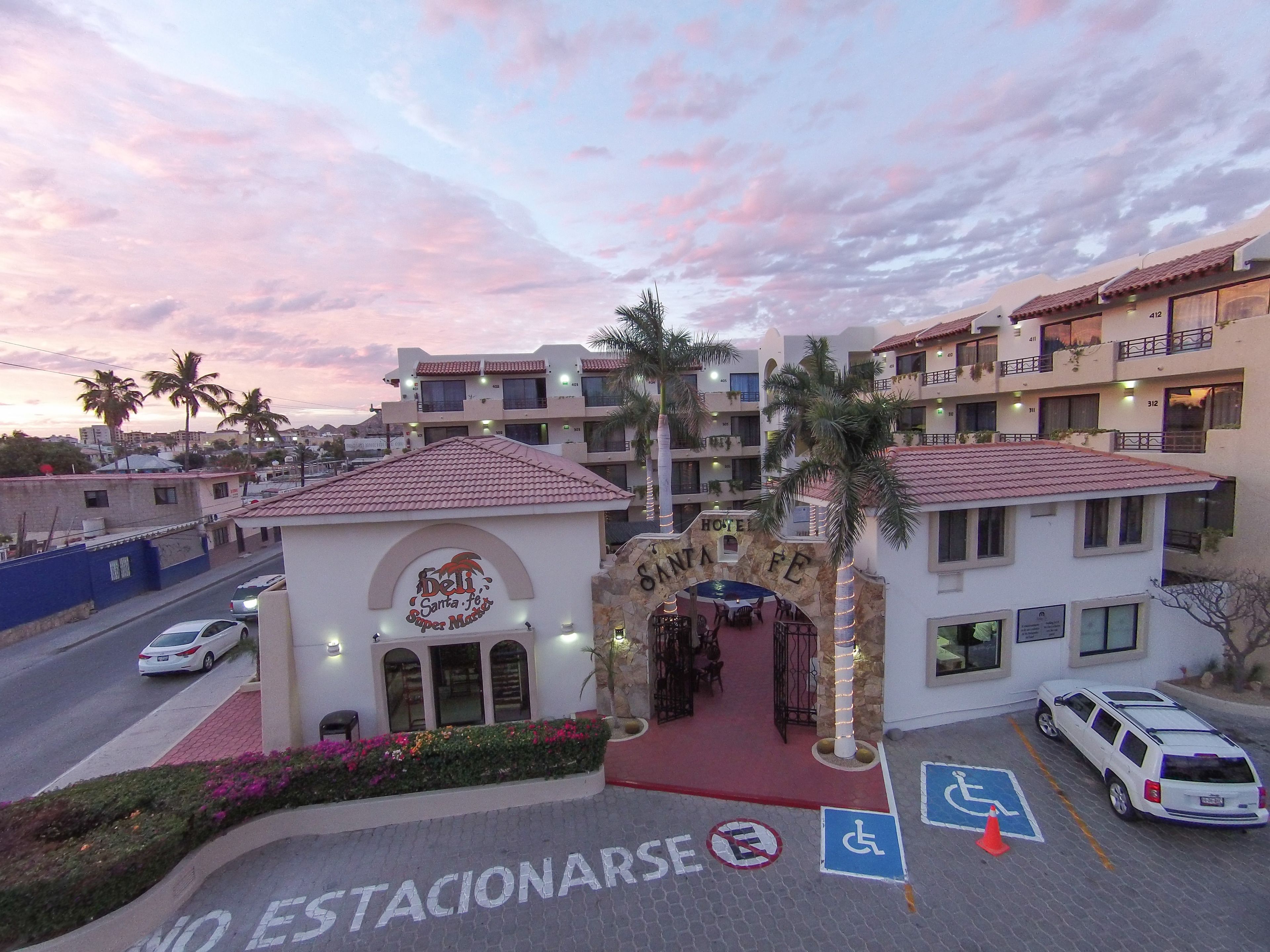 A hotel entrance with a sign reading "Hotel Santa Fe Super Market" and a parking area marked "No Parking."