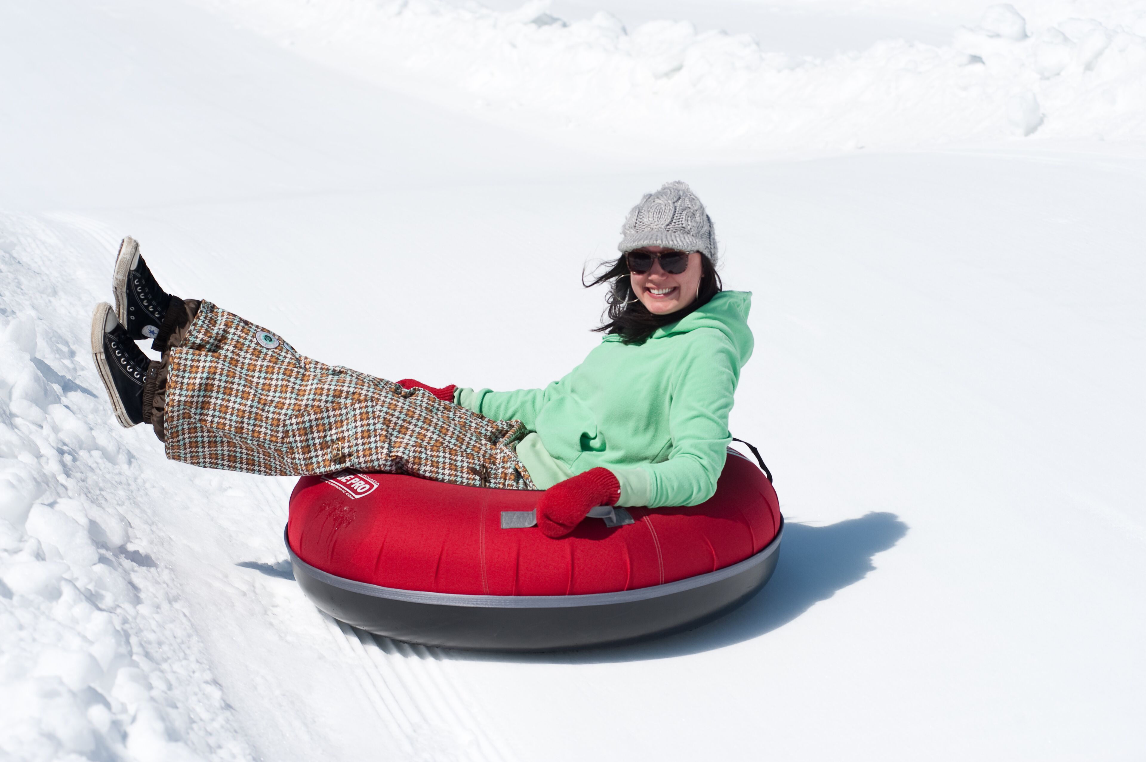 A person sledding on a snow-covered slope.