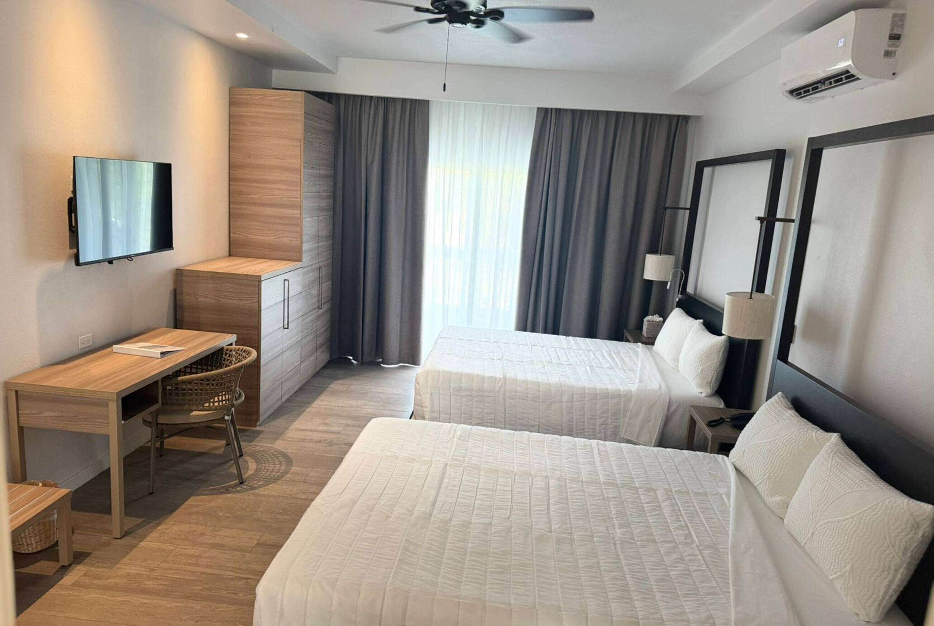 studio, 2 queen beds, poolside | in-room safe, individually decorated, individually furnished, desk