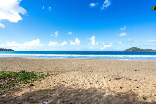 On the beach, white sand, sun loungers, beach towels