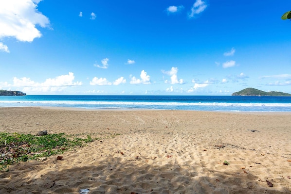 On the beach, white sand, sun loungers, beach towels