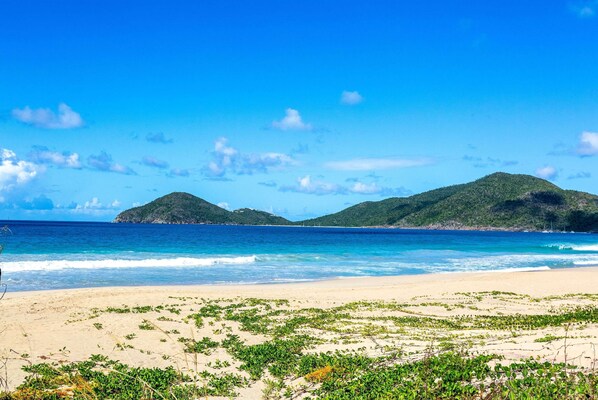 On the beach, white sand, sun loungers, beach towels