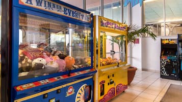Playful claw machines stocked with plush toys and prizes in a clean, well-maintained space.