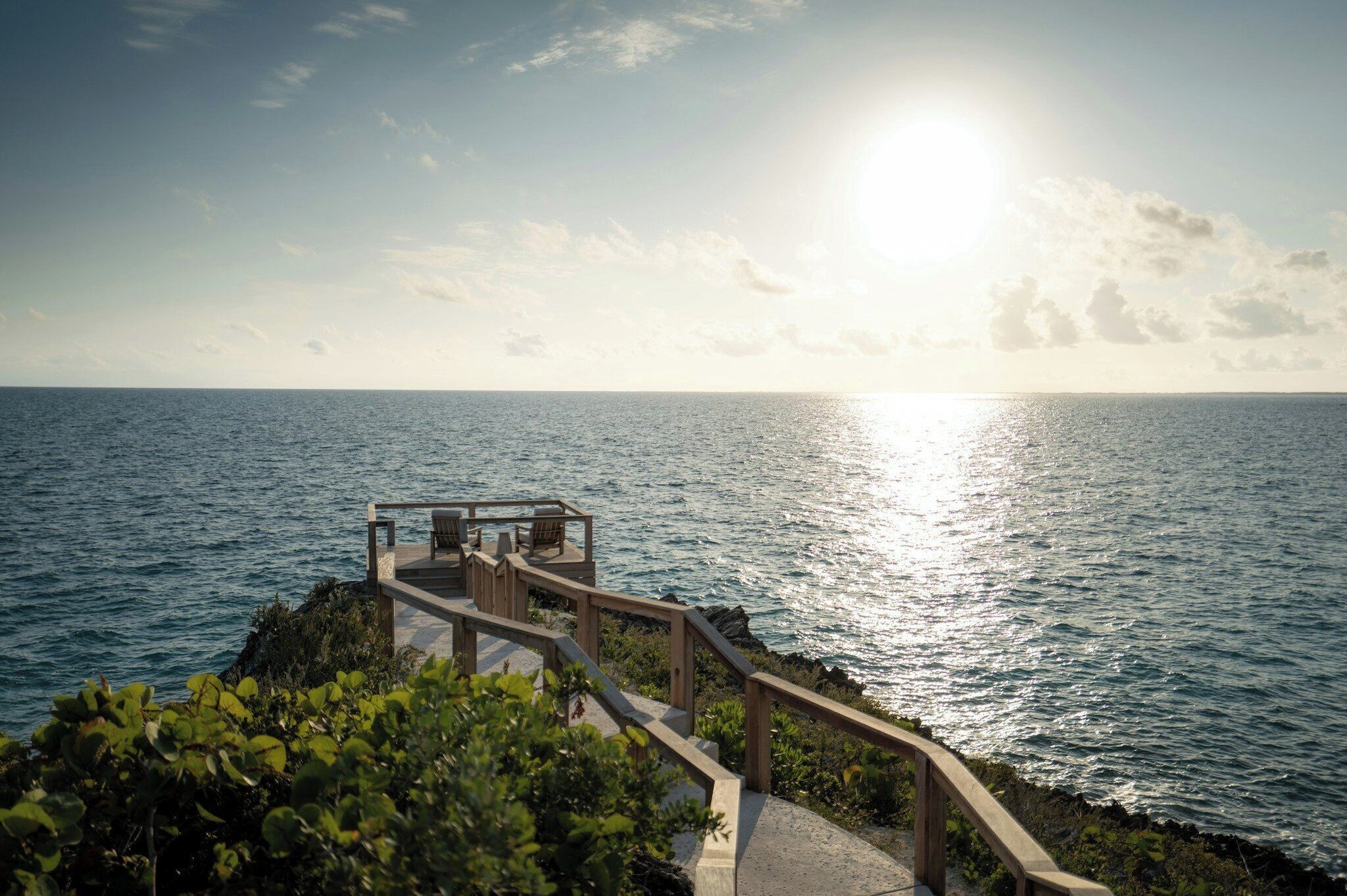 A coastal walkway with a wooden structure overlooking the sea.
