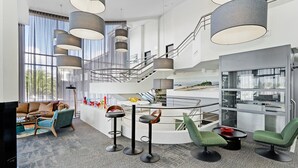 A modern interior with a staircase, bar area, and seating. - Best Western Plus Apollo Hotel Newcastle (Charlestown)