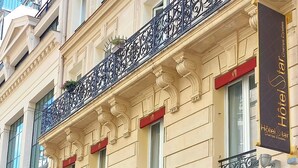 A hotel facade with ornate balconies, large windows, and a prominent 'Hotel Star' sign. - Star Champs Elysées (Paris)