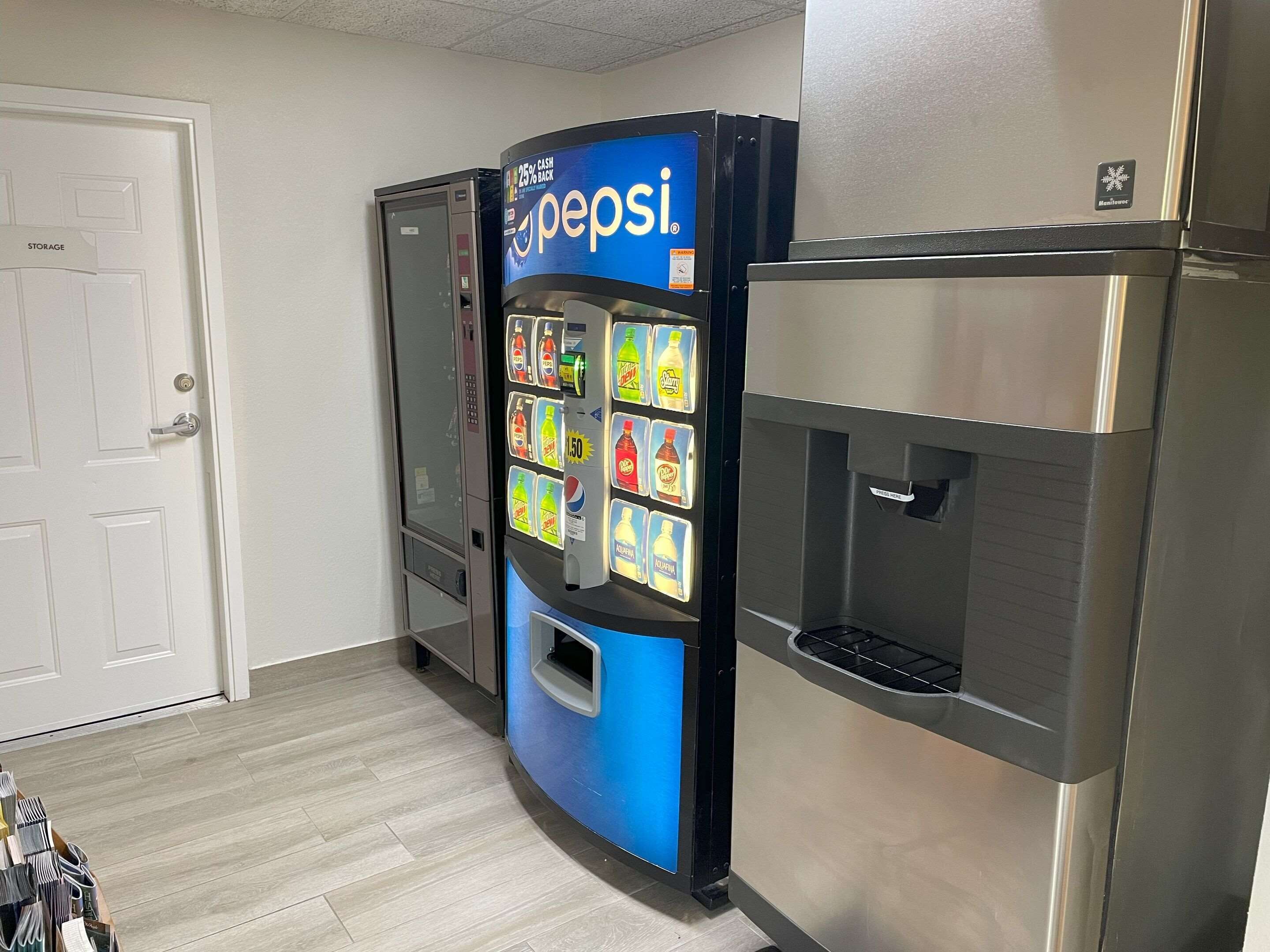 A vending machine with Pepsi and other beverages, a storage room, and a refrigerator.