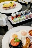 A breakfast setting with eggs, sausages, and toast.