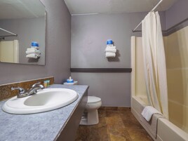 A bathroom with a sink, toilet, and bathtub.