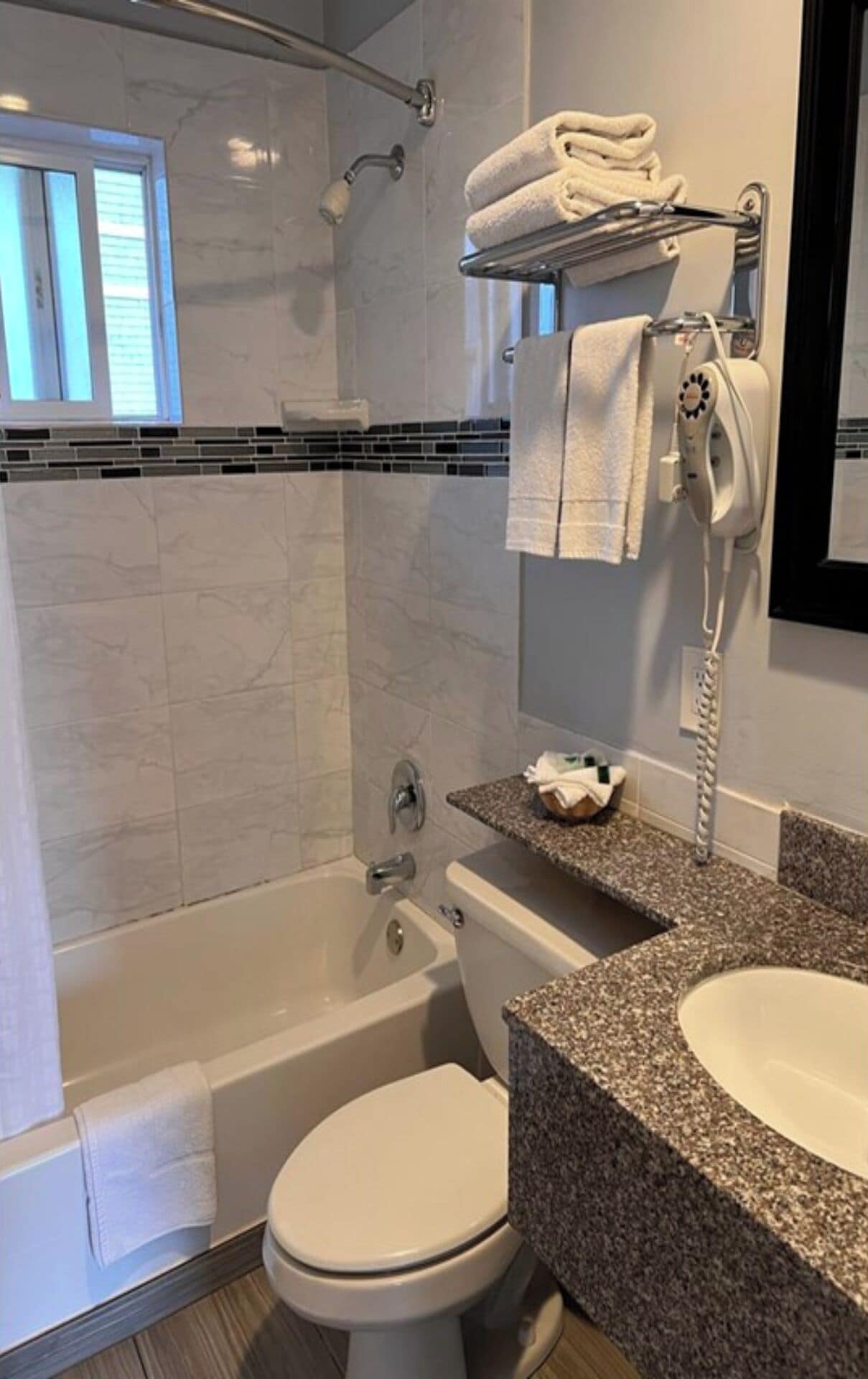 A bathroom with a bathtub, toilet, and sink.
