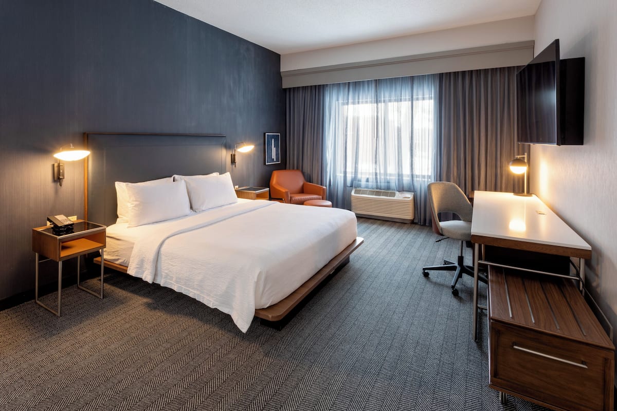 Premium bedding, desk, laptop workspace, blackout curtains
