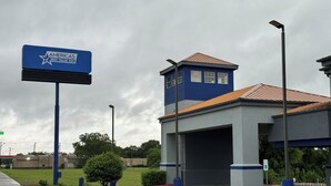 A building with a blue and grey color scheme, a prominent sign for 'Americas Best Value Inn', and a parking area with a fire lane. - Americas Best Value Inn & Suites Haltom City Ft. Worth (Haltom City)