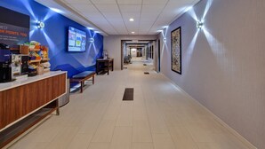 A hotel lobby with a reception desk, seating area, and a long corridor leading to the rooms. - Holiday Inn Express & Suites Absecon-Atlantic City by IHG (Absecon)
