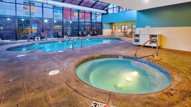 An indoor swimming pool with a hot tub, lounge chairs, and a reception area. - Holiday Inn Express & Suites Absecon-Atlantic City by IHG (Absecon)