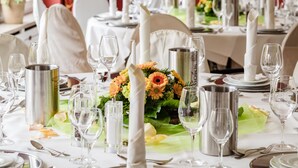 A formal dining table set with white tablecloths, silverware, and tall candles. - Hotel Zum Zeppelin (Hamburg)