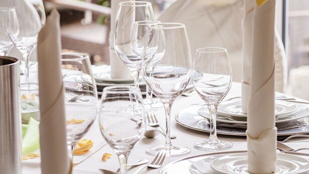 A table set for a formal dining experience with white napkins, silverware, and clear glassware. - Hotel Zum Zeppelin (Hamburg)