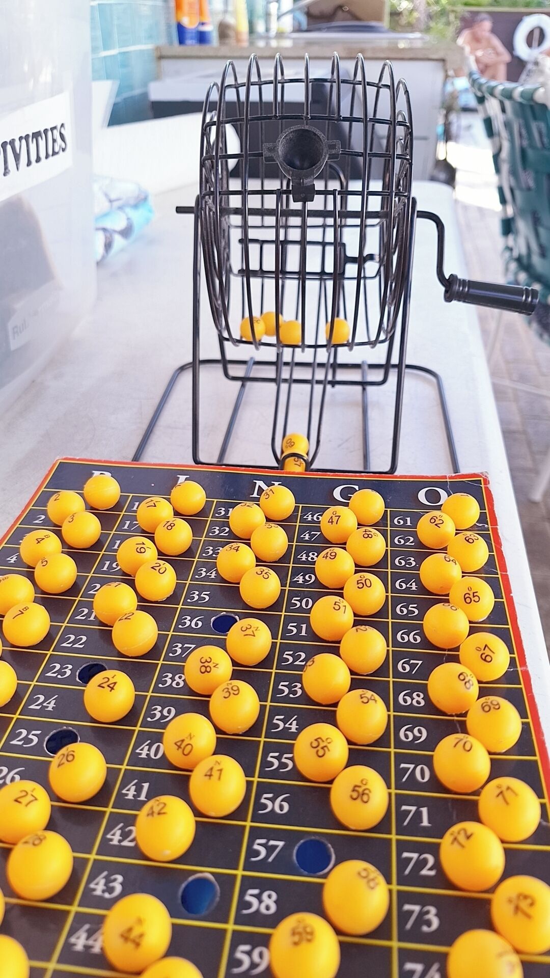 A game board with numbered tiles and a wire rack in the background.