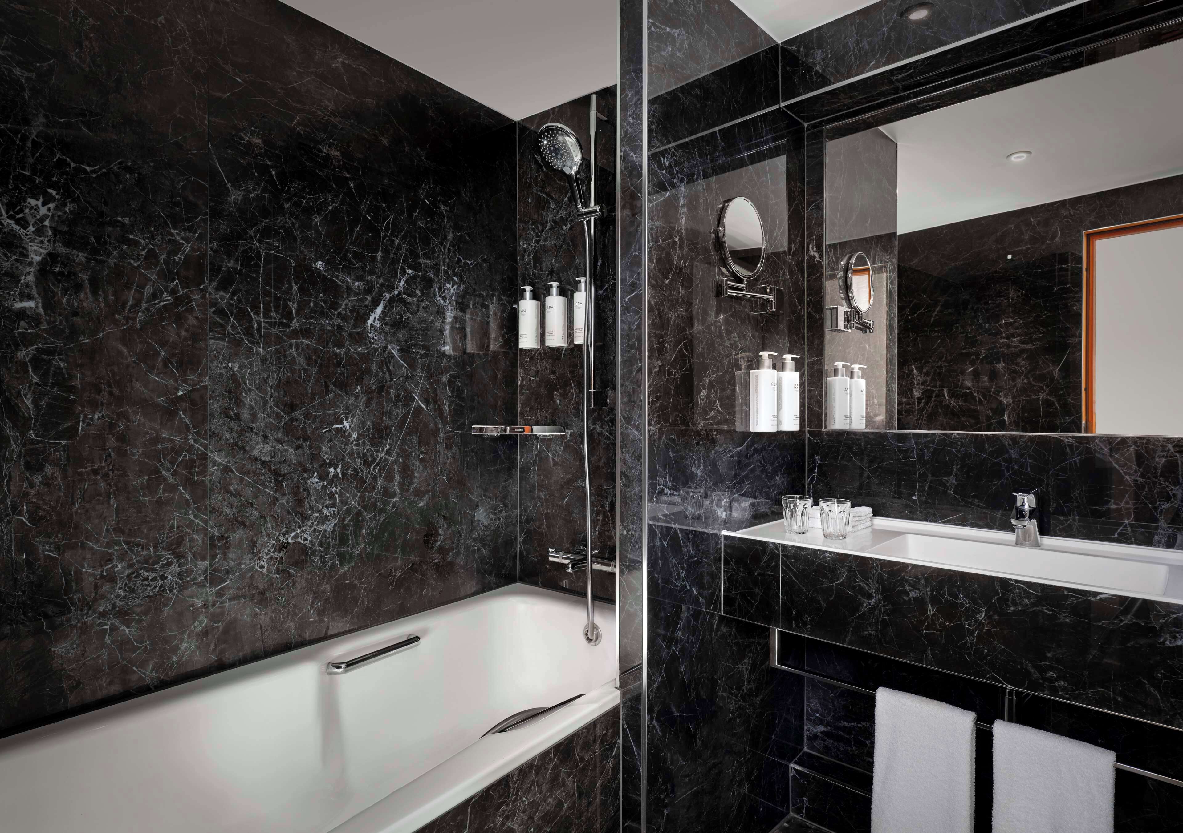 combined shower/bathtub, designer toiletries, hair dryer, towels