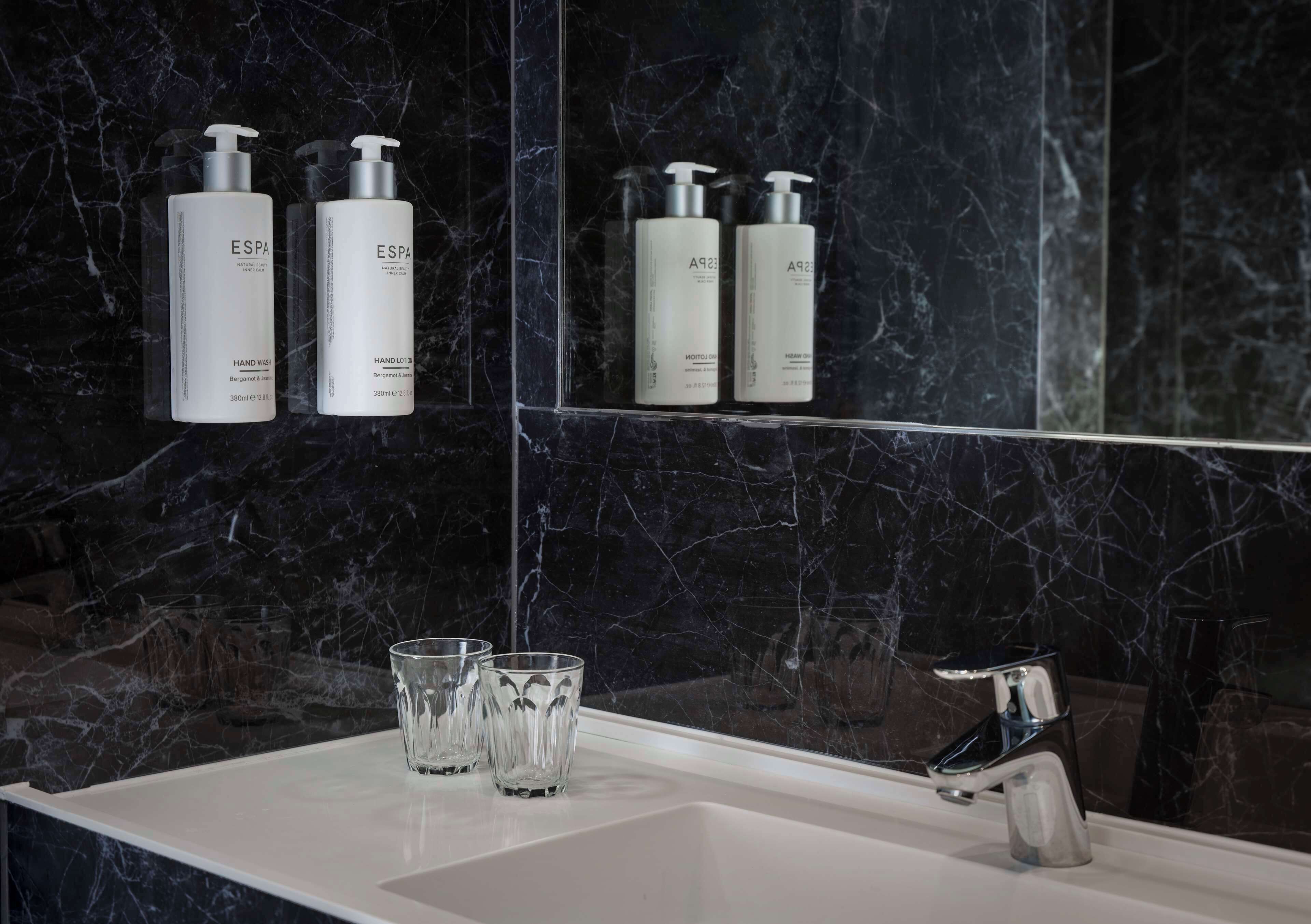 combined shower/bathtub, designer toiletries, hair dryer, towels