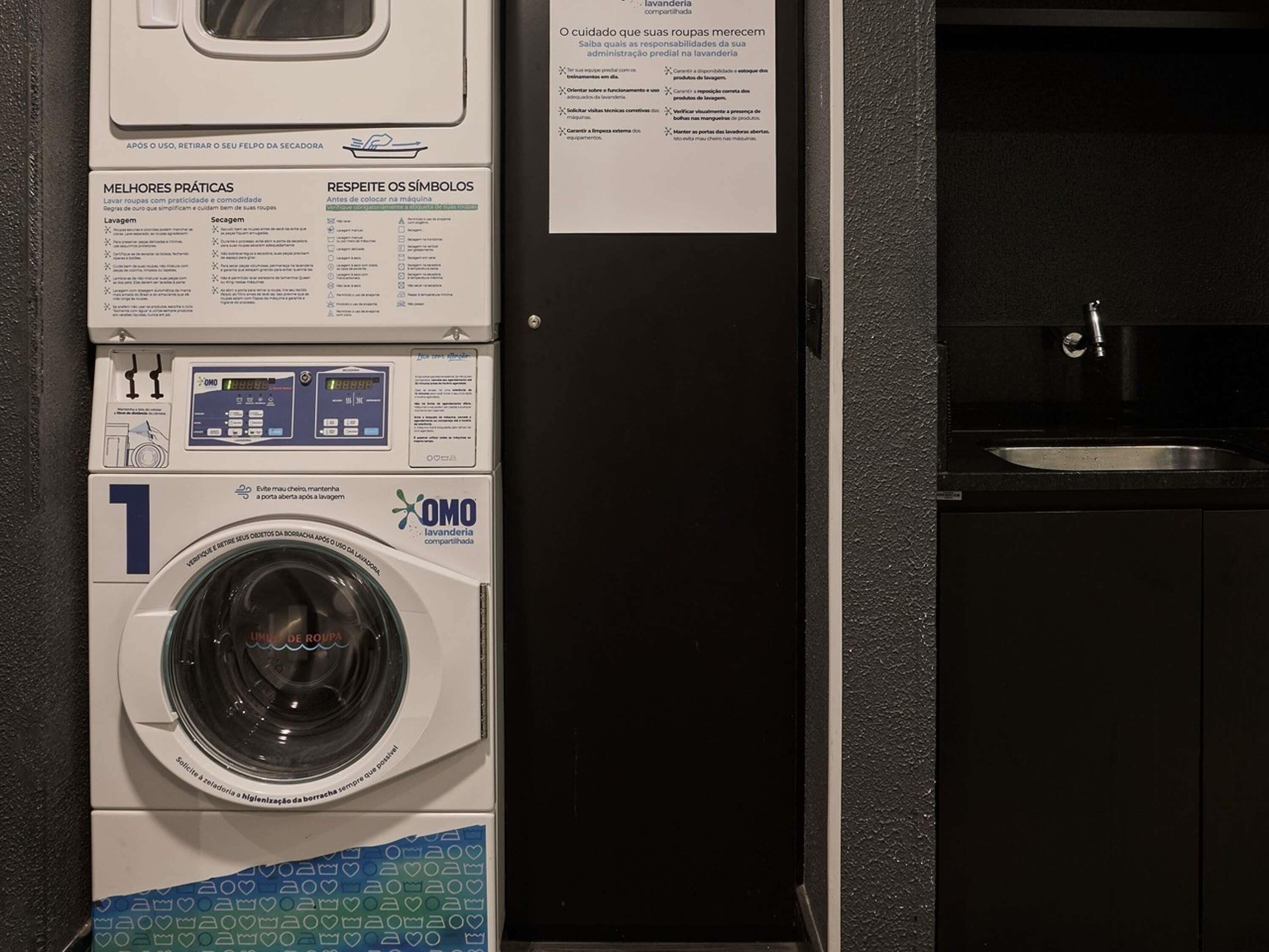 A laundry area with a front-loading washing machine, a control panel, and a sink.
