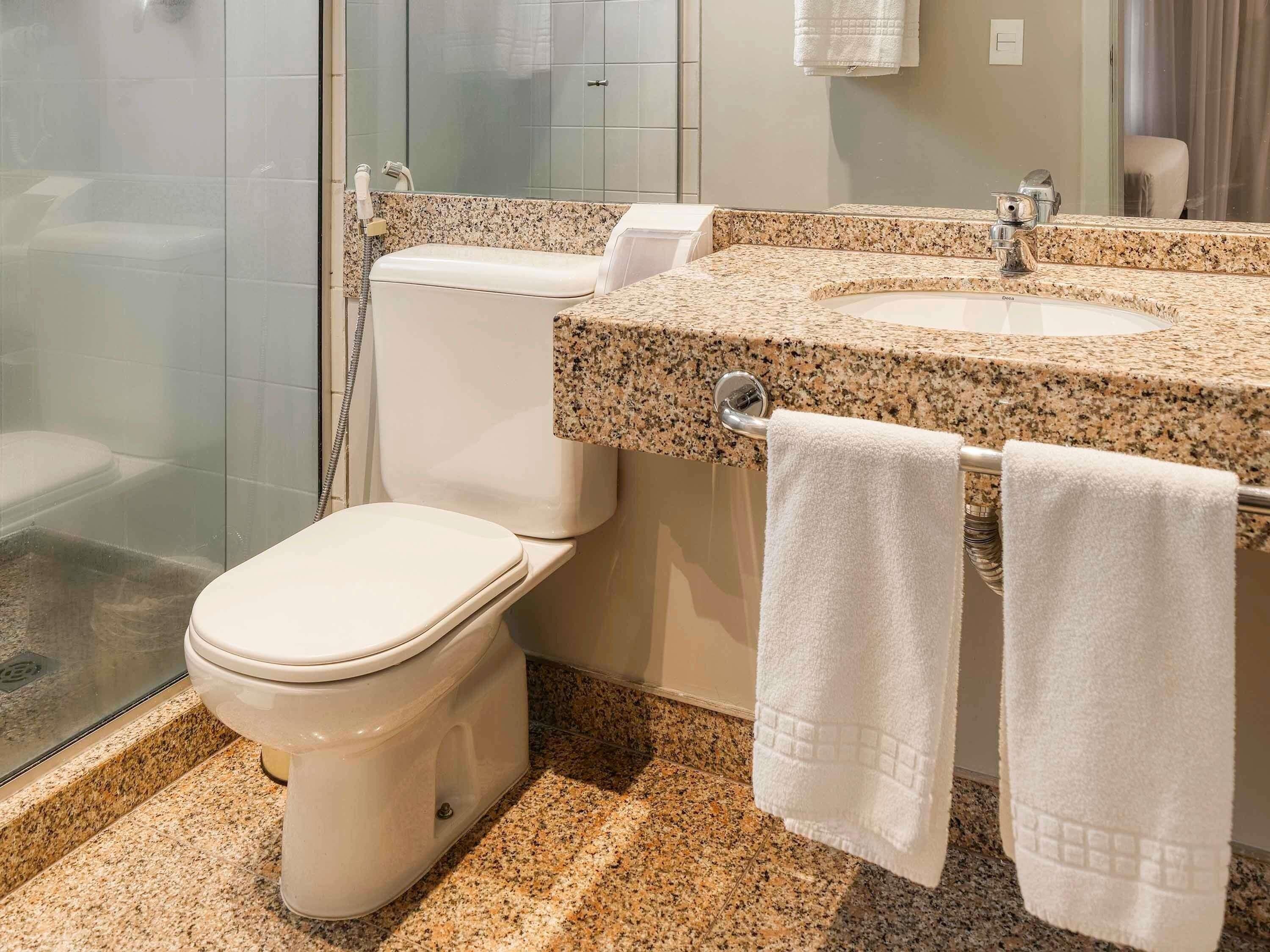 Un baño con inodoro, lavamanos y ducha.