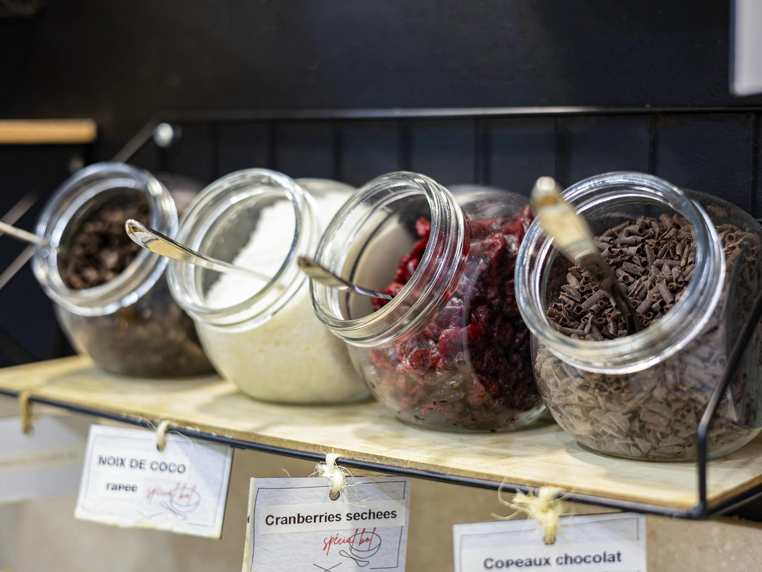 A display of jars with labels indicating different types of preserves.