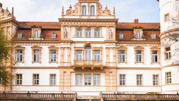 A grand building with a central fountain, symmetrical gardens, and a staircase leading to the entrance. - Schlosshotel Schkopau (Schkopau)