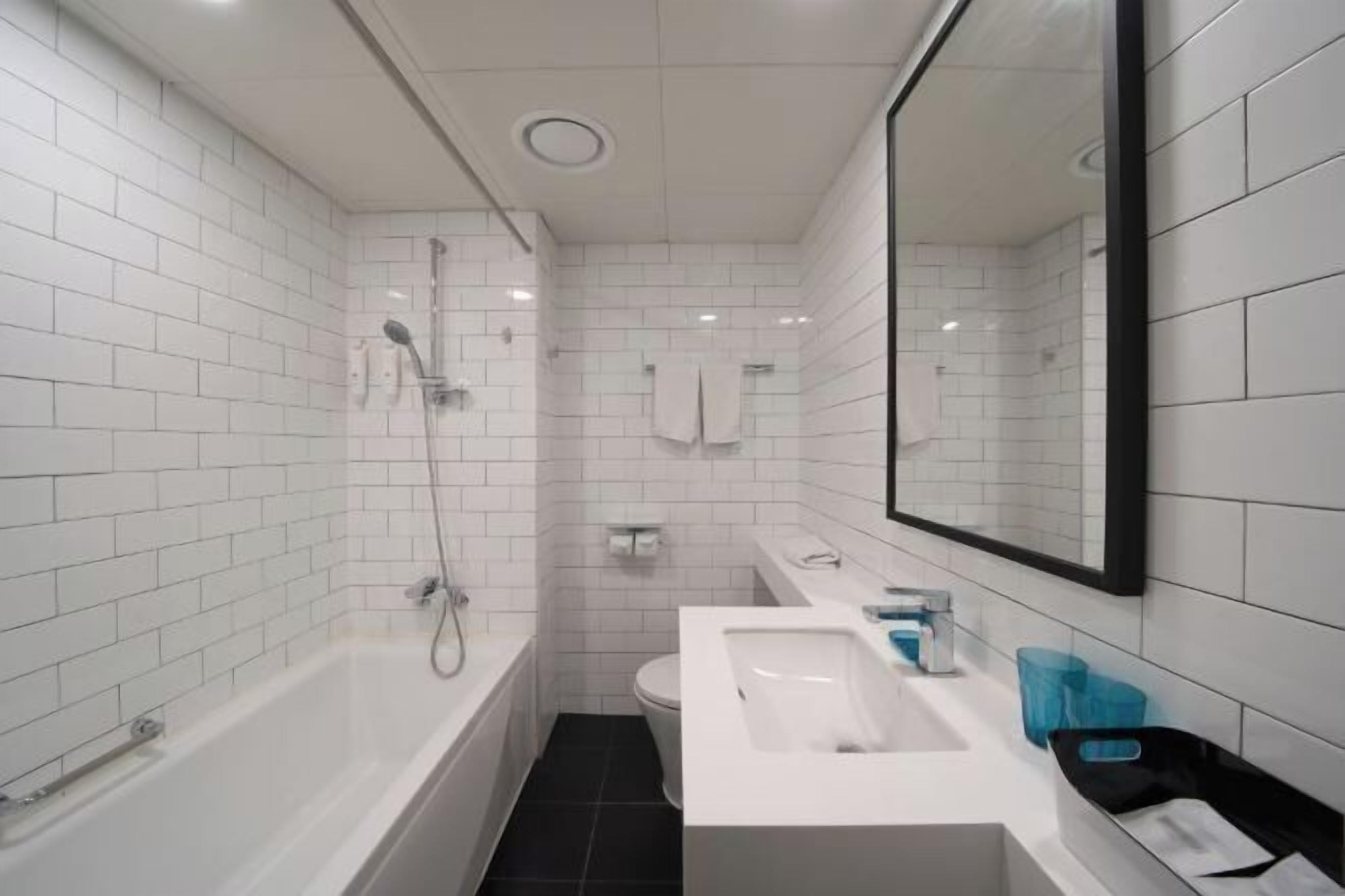 Badkamer | Een diep bad, gratis toiletartikelen, een haardroger, badjassen