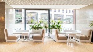 A modern lobby with a seating area, large windows, and potted plants. - New Seoul Hotel (Seoul)