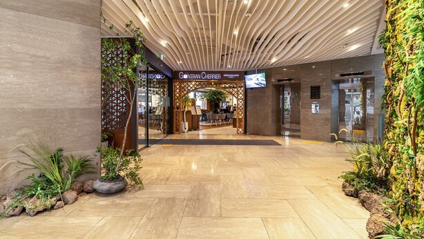 A modern hotel lobby with a central atrium, a restaurant, and a reception area. - New Seoul Hotel (Seoul)