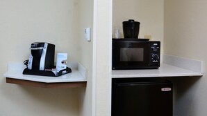 A kitchenette with a coffee maker, a microwave, and a small refrigerator. - Holiday Inn Express & Suites Raleigh Durham Airport at RTP by IHG (Durham)
