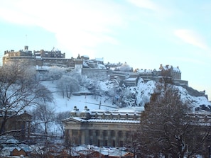 A historic building complex with multiple structures, including a prominent tower and a large central building with classical architecture.
