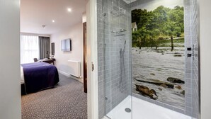 A hotel room with a large bed, a desk, and a shower with a nature-themed glass door. - Mercure Inverness Hotel (Inverness)